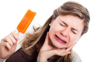 Woman With Hypersensitive Teeth Eating Ice Lolly