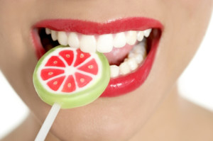 Colorful Lollypop in perfect woman teeth